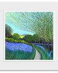 A square art print depicting a scenic landscape with a winding path through a field of purple flowers and green trees, presented with a wide white mat border.
