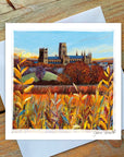 An Autumn day at Durham Cathedral in background , foreground with lush yellow/orange foliage .
