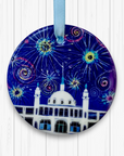 Circular ceramic decoration hung against a white background. It features the Whitley Bay Spanish City Dome under a dark blue sky of colourful fireworks.
