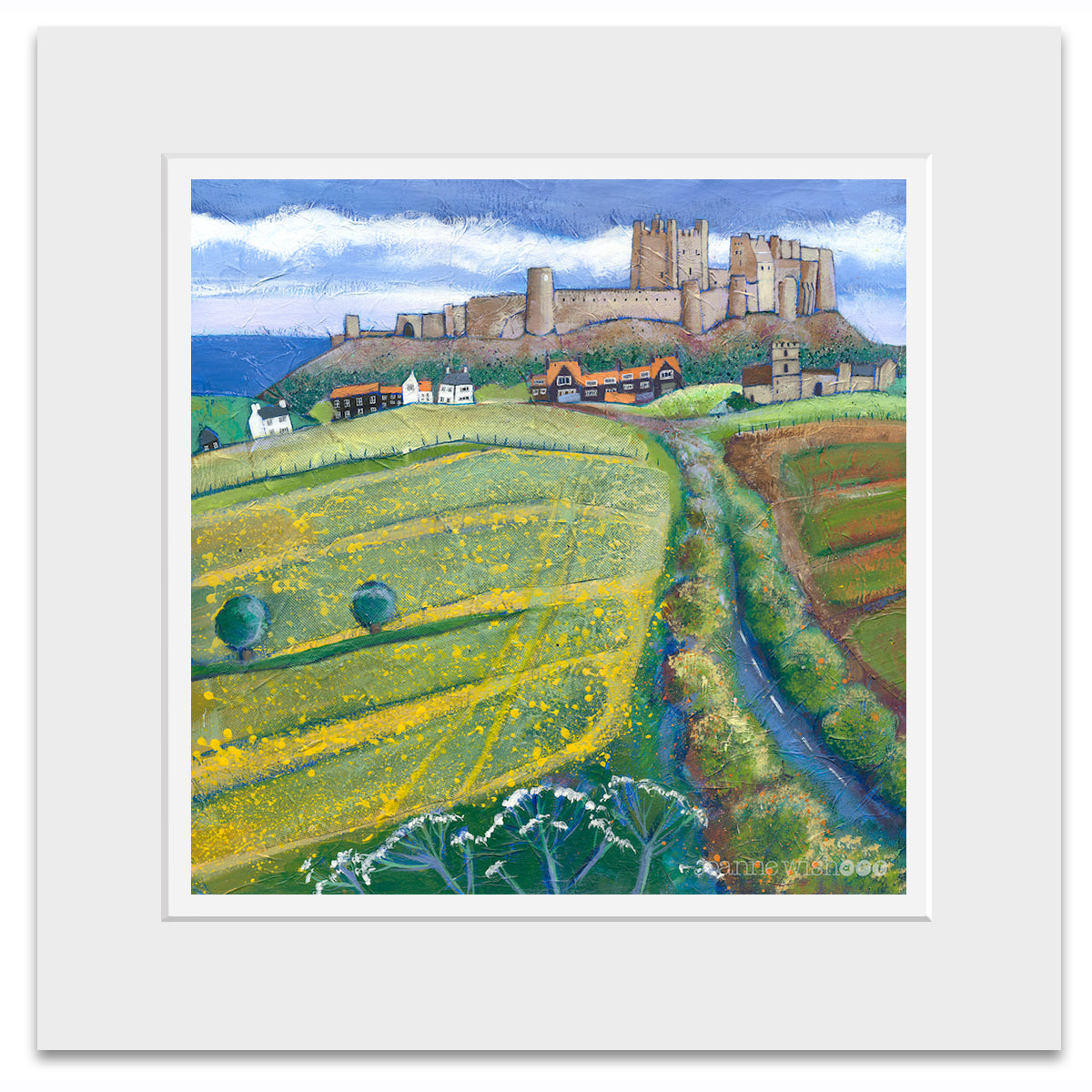 A mounted print of Bamburgh castle with a bright yellow field of flowers dominating the foreground.