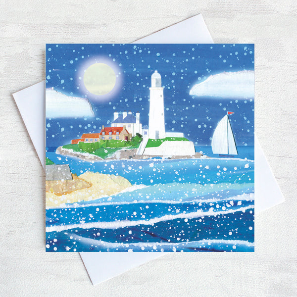 A festive snow scene of St Mary's Island  with the moon shining brightly in the sky.