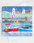 A snowy scene on the north Shields Fish quay with a red boat taking centre stage.