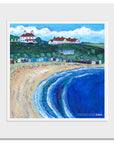 A mounted print of foldingham Bay in the Scottish Borders featuring a row of old beach huts on the sand.