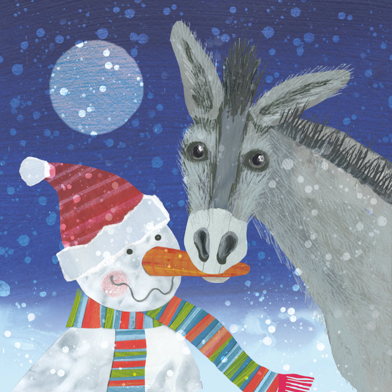 A donkey eats the carrot on a snowmans nose christmas card. There is snow fluttering down a moonlit sky. 