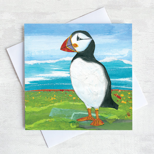 A coastal greetings card featuring a black and white puffin with colourful beak.