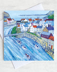 A greetings card featuring a painting of the fishing village of Staithes in North Yorkshire.