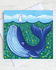 A greetings card featuring a blue whale under the water.