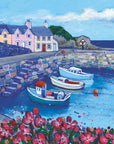 Pink flowers with green leaves capture the viewer's eye in the foreground. Three boats moored in the harbour are then visible encased by a stone brick harbour wall. With details such as steps and a metal ladder with subtle colour in the bricks. Houses in beautiful shades of orange, pink and cream can be observed beyond Dunure’s harbour wall. With a cliff face and darker ocean visible towards the back of the image.