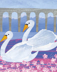 Pink bubble flowers occupy the foreground on a pink and purple toned river. A grey arched bridge can be observed in the background. The main focus of the image is two swans with an orange/yellow toned beak. They are swimming in the same direction with happy expressions.