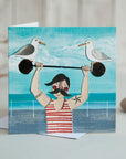 Seaside Strongman | Greetings Card