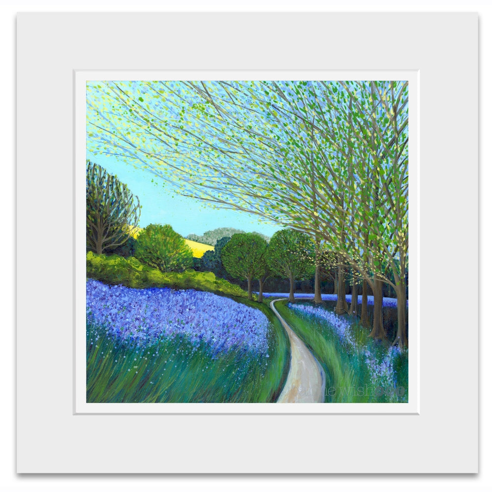 A square art print depicting a scenic landscape with a winding path through a field of purple flowers and green trees, presented with a wide white mat border.