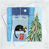 Greeting card with a cat, Christmas tree, and window view of boats on water.