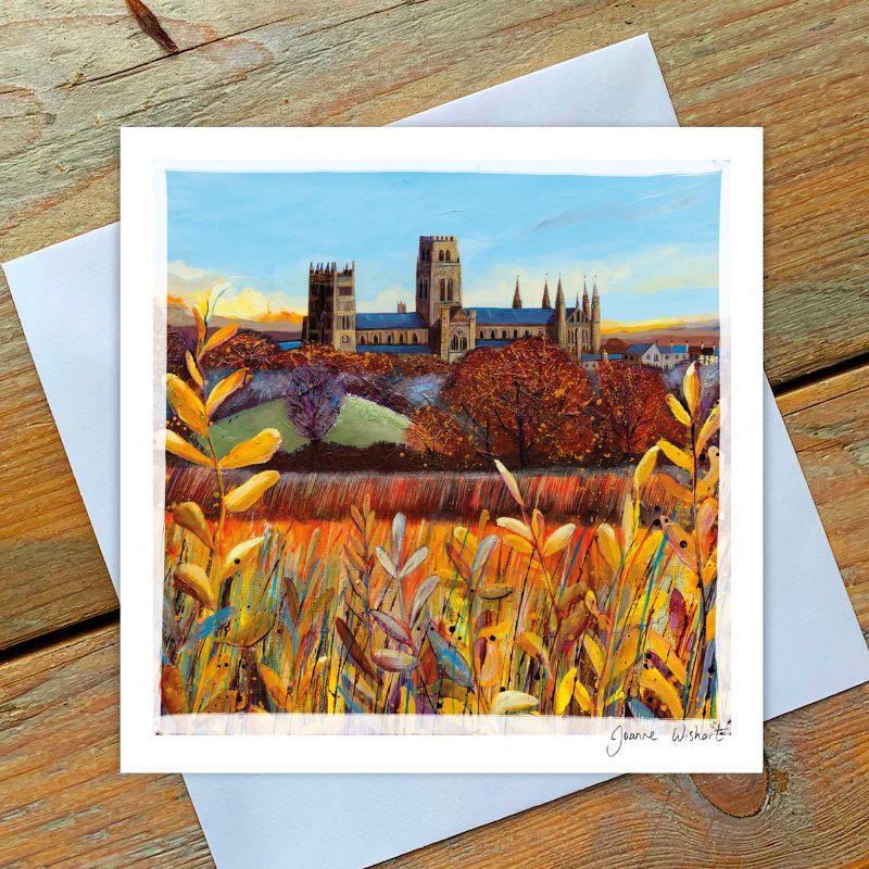 An Autumn day at Durham Cathedral in background , foreground with lush yellow/orange foliage .