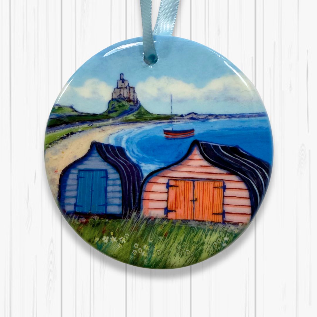Decorative ornament with a scenic design of Boats sheds on a Lindisfarne background
