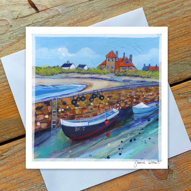 At Beadnell Harbour with boats and beautiful blue sky.