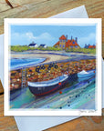 At Beadnell Harbour with boats and beautiful blue sky.