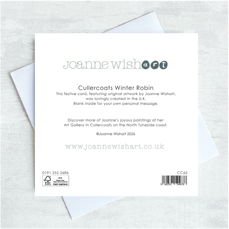 The back of a Joanne Wishart art card showing printed text ,placed on top of white envelopes on a light gray textured surface.