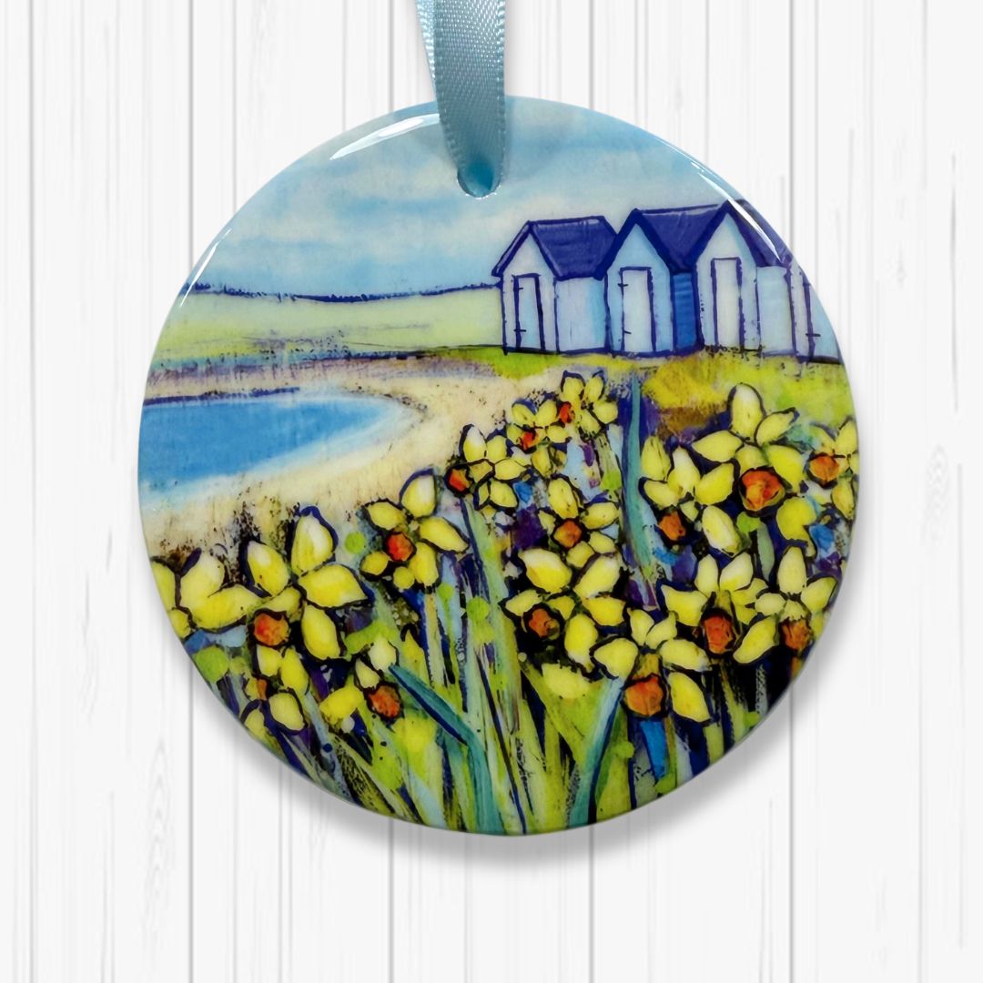 Decorative ornament with a scenic design of Beach Huts and Daffodils on a white background