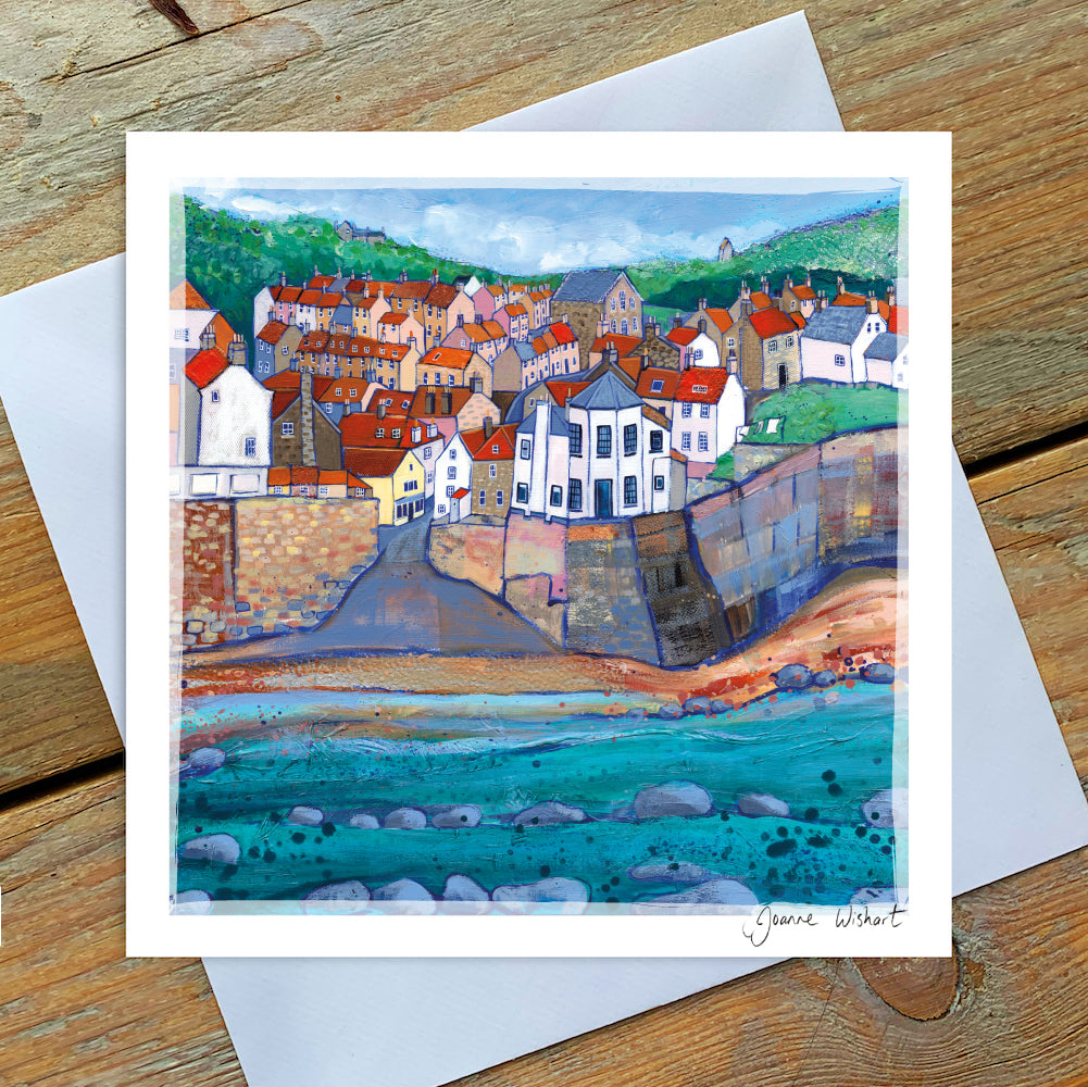 A greetings card showcasing a view of robin Hoods Bay village from the beach looking up the hill.