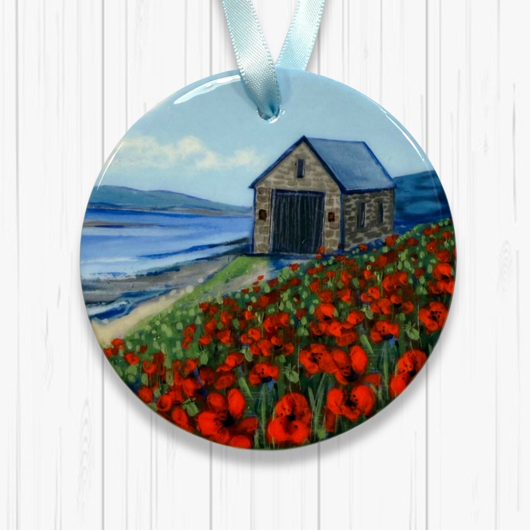 Round ornament with a painting of a Old Lifeboat station and red poppies on a white background