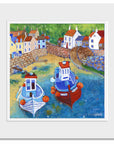 A mounted art print of fishing boats in Staithes harbour.