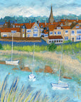 A print of Alnmouth village with the river flowing across the foreground and sailing boats bobbing on the water.