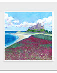 A mounted print of Bamaburgh Castle, beach and field of purple wildflowers.