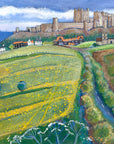 A striking painting of Bamburgh Castle with bright yellow flowered fields in the foreground and road sweeping into the village. 