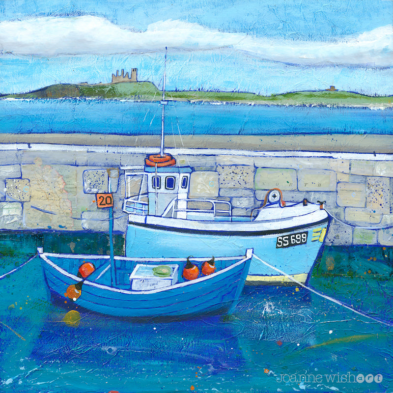 A fine art print of Beadnell harbour fishing boats with Dunstanburgh Castle in the distance.