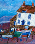 A charming fine art print of a fishermans cottage and coble boats at Robins hood Bay.