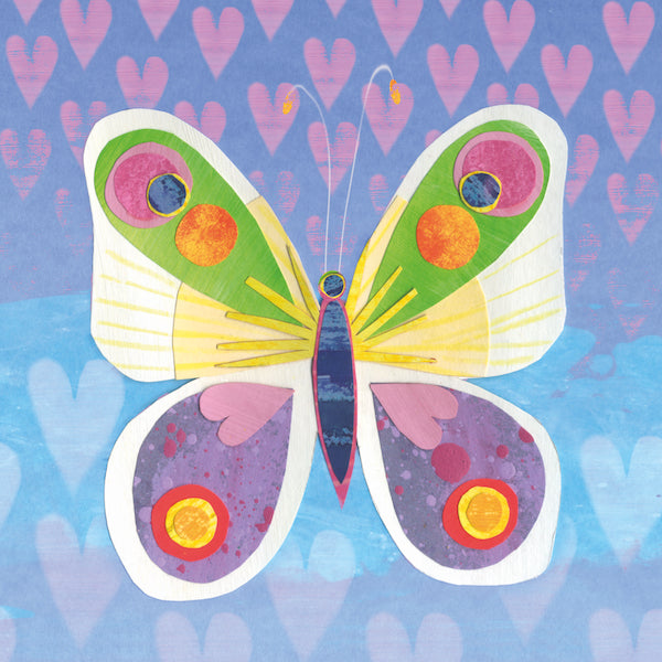 A colorful card with a symmetrical butterfly as the main focus. The butterfly has a blue body with a pink outline as well as big white wings with yellow detailing. The top part of the wing has green embellishments whereas the bottom has purple with fun heart shaped features. The background is multi toned blue, purple and pink with hearts underlaid. 