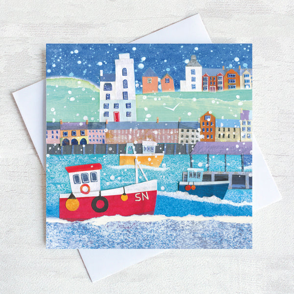 A snowy scene on the north Shields Fish quay with a red boat taking centre stage. 
