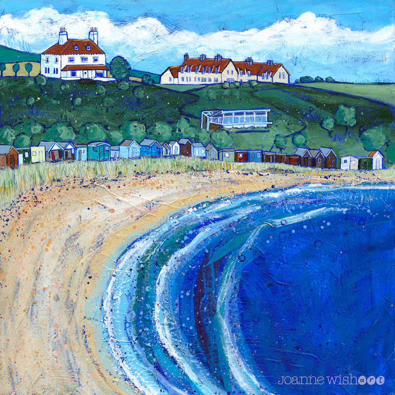 A colourful print of Coldingham Bay featuring a sandy beach and row of colourful sheds and beach huts nestled at the bottom of the hillside.