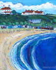 A colourful print of Coldingham Bay featuring a sandy beach and row of colourful sheds and beach huts nestled at the bottom of the hillside.