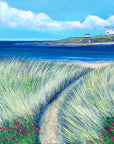 A bright and colourful painting of Coquet Island featuring a white lighthosue on a ocky island. There are pink wildflwers in the sea grassy sand dunes in the foreground. THe sea is blue and the waves gently lap up the shore. 
