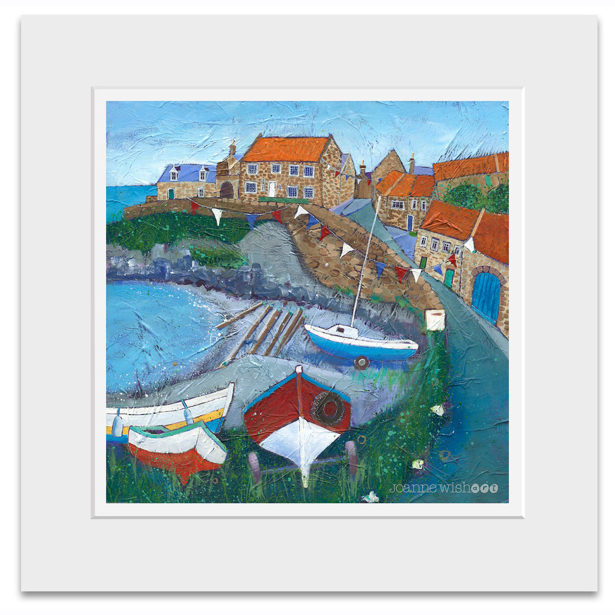 A mounted print of Craster in Northumberland featuring colourful boats and bunting in the bay.