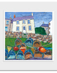 A mounted print of lobster pots and a fishermans cottage painted in a quirky style.