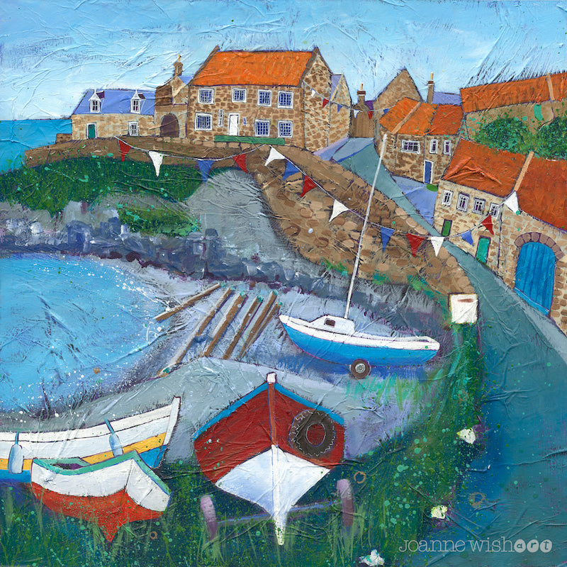 An uplifting print of Craster harbour in northumberland with boats and bunting bin the bay.