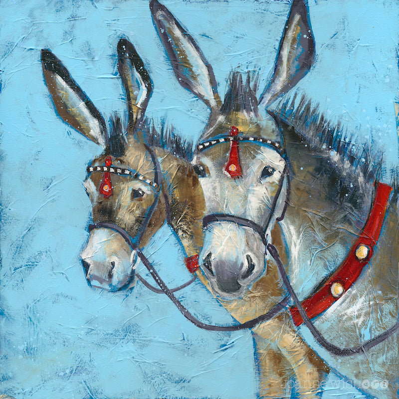 A print of two seaside donkeys bridled up with red accents on the leatherwork. 