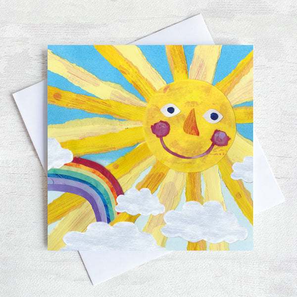 Greetings Card Featuring a smily faced sun and a rainbow.