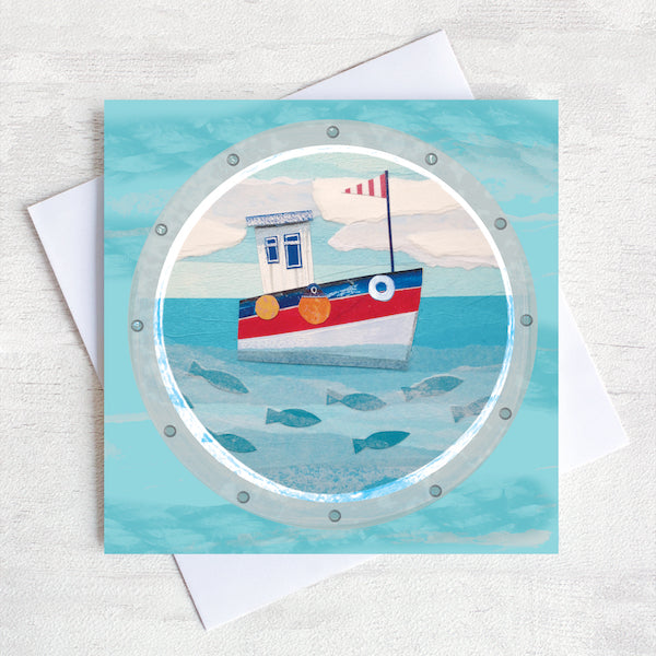 A greetings card featuring a cute fishing boat with fish swimming in the sea below.