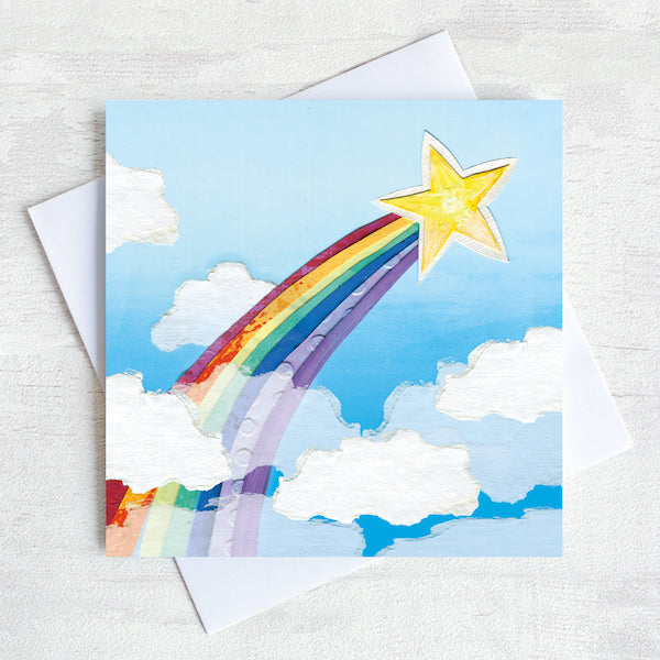 A greetings Card featuring a shooting star and a rainbow. 