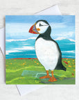 A coastal greetings card featuring a black and white puffin with colourful beak.