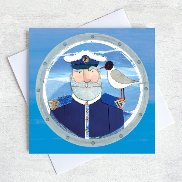 A greetings card featuring a beardy ships captain with a gull on his shoulder peeking through a porthole.