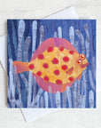 A quirky greetings card featuring a spotty plaice fish swimming through the sea weed. 