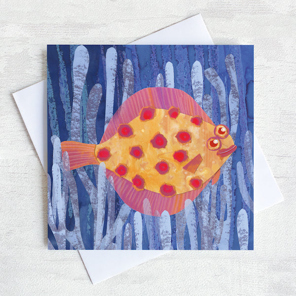 A spotty Plaice fish in a bed of purple seaweed greetings card.