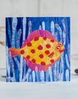 A  greetings card featuring a happy plaice spotty fish swimming through sea weed.