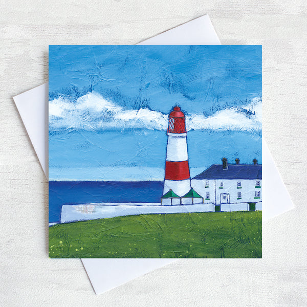 A coastal greetings card featuring Souter lighthouse a red and white striped building in front of the sea.