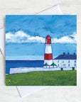 A coastal greetings card featuring Souter lighthouse a red and white striped building in front of the sea.