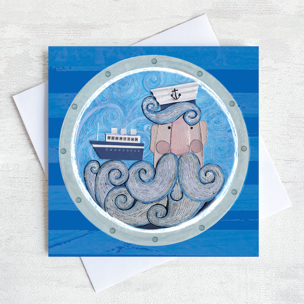 A greetings card featuring a beardy ships captain with a boat sailing in his beard.